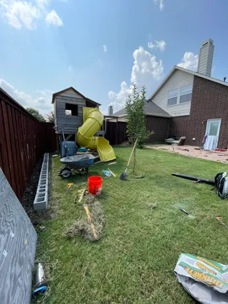 Backyard lawn renovation and new sod around a play set